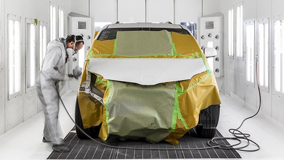 Collision Center Technician Painting a Vehicle | Fort Wayne Toyota in Fort Wayne IN