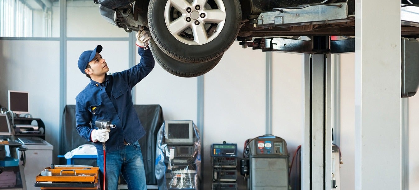image of a mechanic working on a car